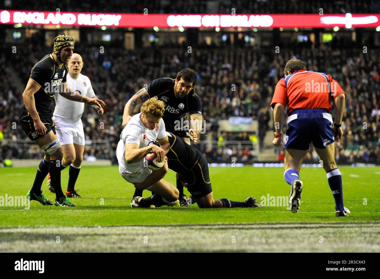 Billy Twelvetrees of England dives over to score a try on his debut during the RBS 6 Nations match between England and Scotland at Twickenham on Satur Stock Photo