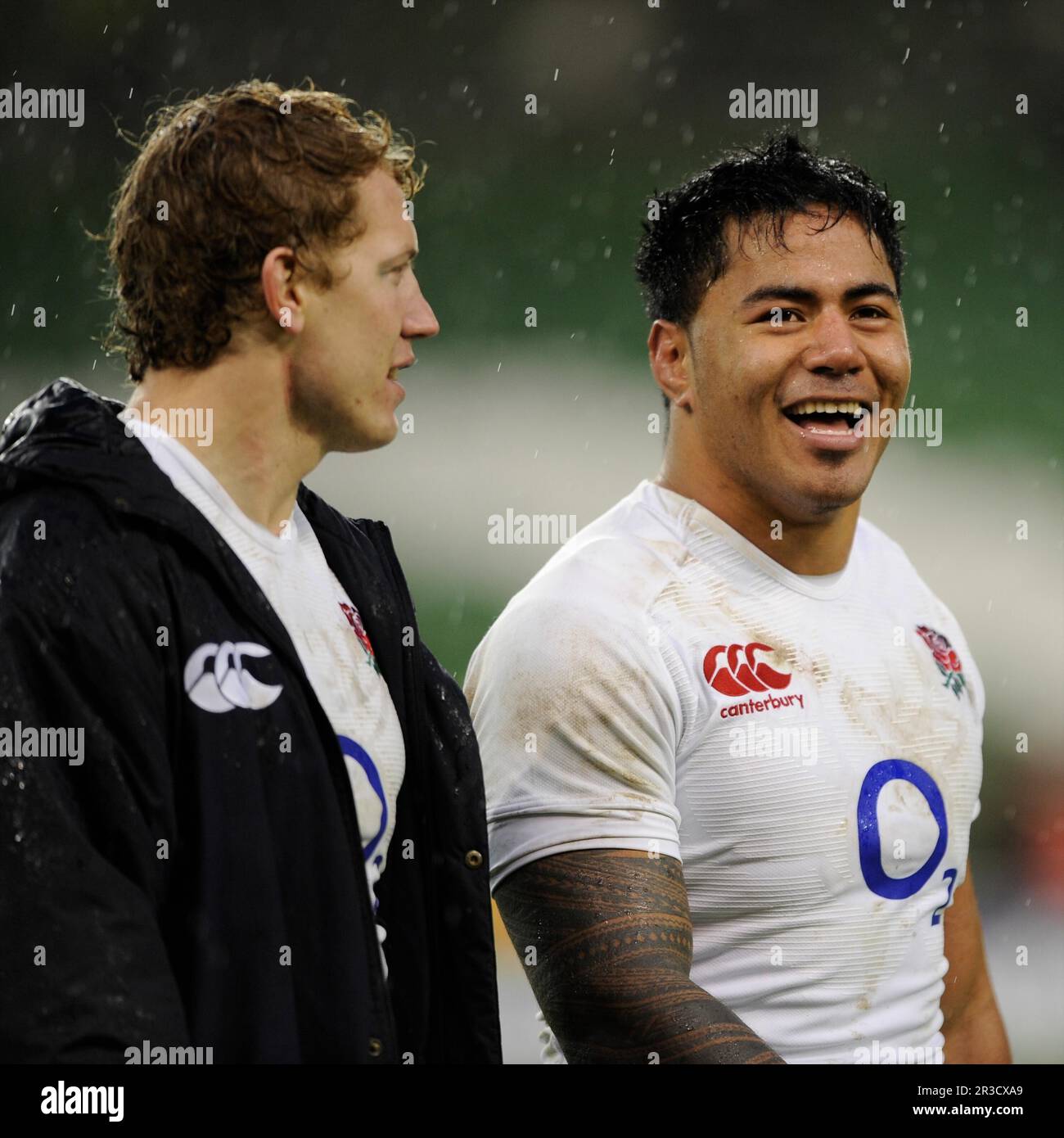 Manu Tuilagi of England (right) smiles with team mate Billy Twelvetrees of England after winning the RBS 6 Nations match between Ireland and England a Stock Photo