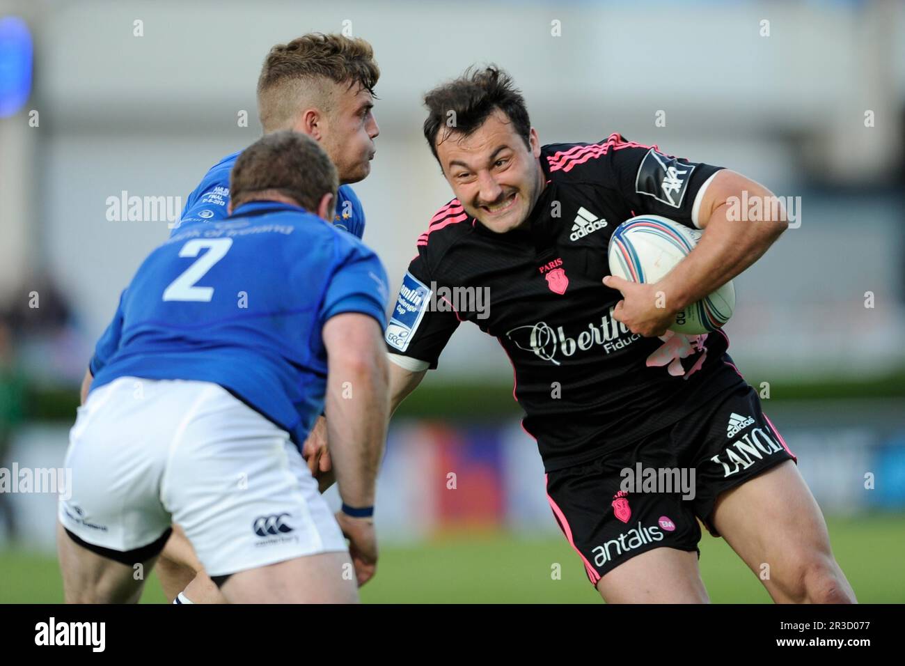 Jv©rv©my Sinzelle of Stade Francais is tackled by Sean Cronin (left) and Ian Madigan of Leinster during the Amlin Challenge Cup Final between Leinster Stock Photo