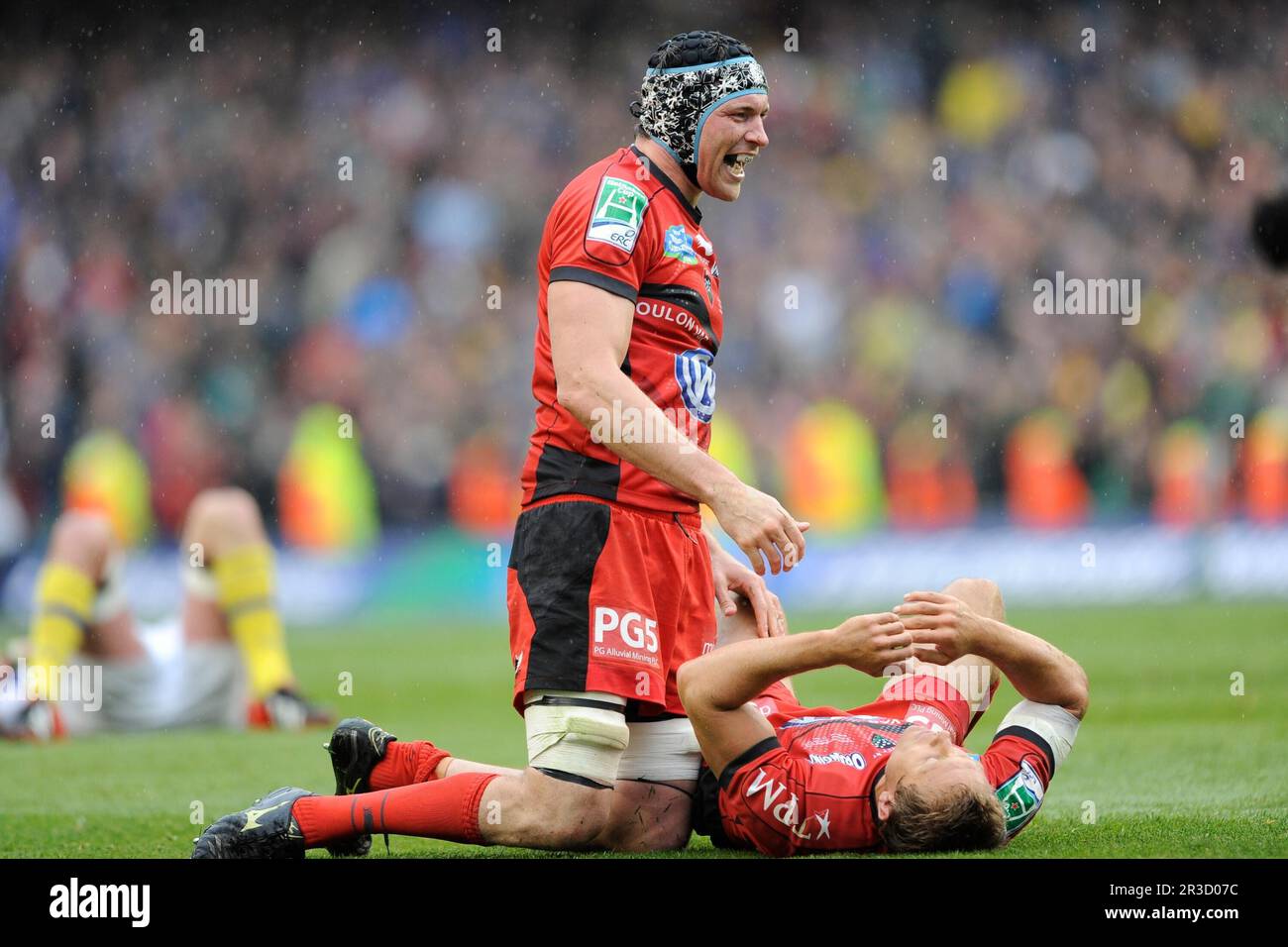 Nick Kennedy (left) congratulates Jonny Wilkinson of RC Toulon after he collapses in delight at the final whistle of the Heineken Cup Final between AS Stock Photo
