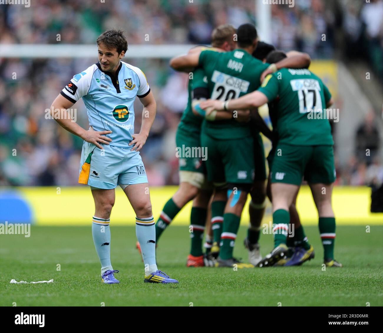 Martin Roberts of Northampton Saints looks dejected as Leicester Tigers celebrate winning the Aviva Premiership Final between Leicester Tigers and Nor Stock Photo