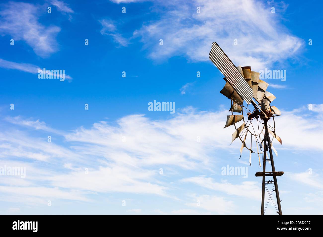 Windmill on a farm in rural grassland area of South Africa Stock Photo