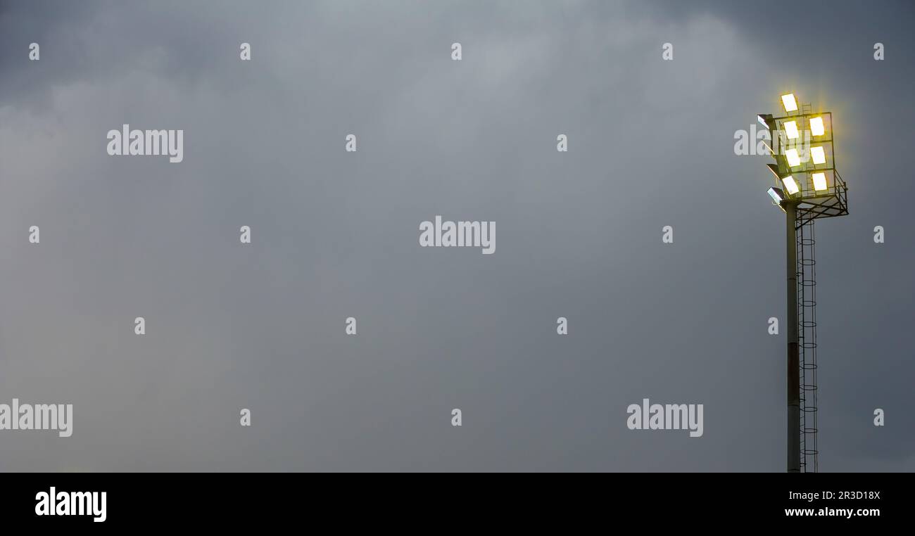 Bright sports stadium lights on a cloudy evening Stock Photo Alamy
