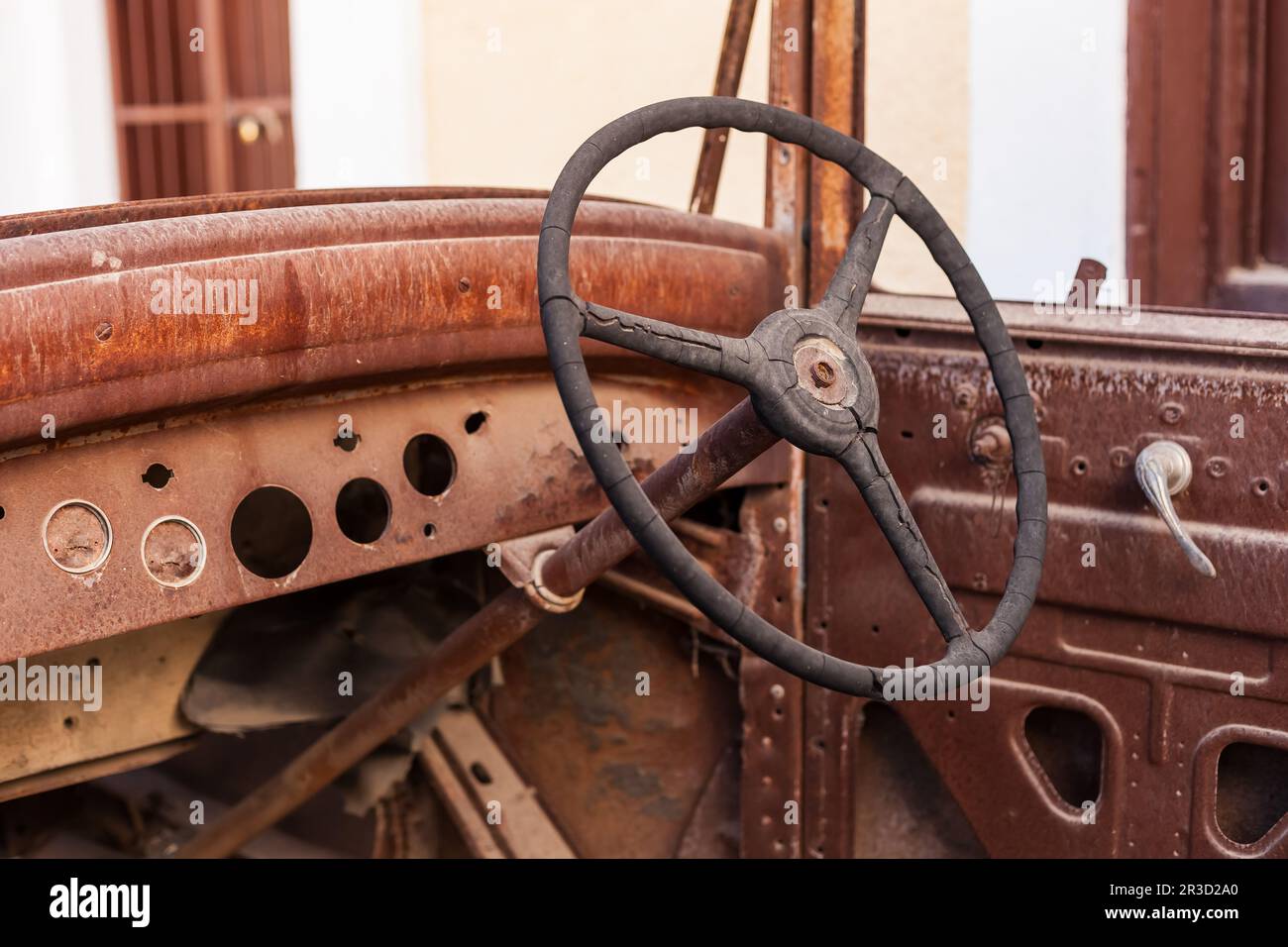 Old rusty motor car steering wheel in a scrap yard Stock Photo