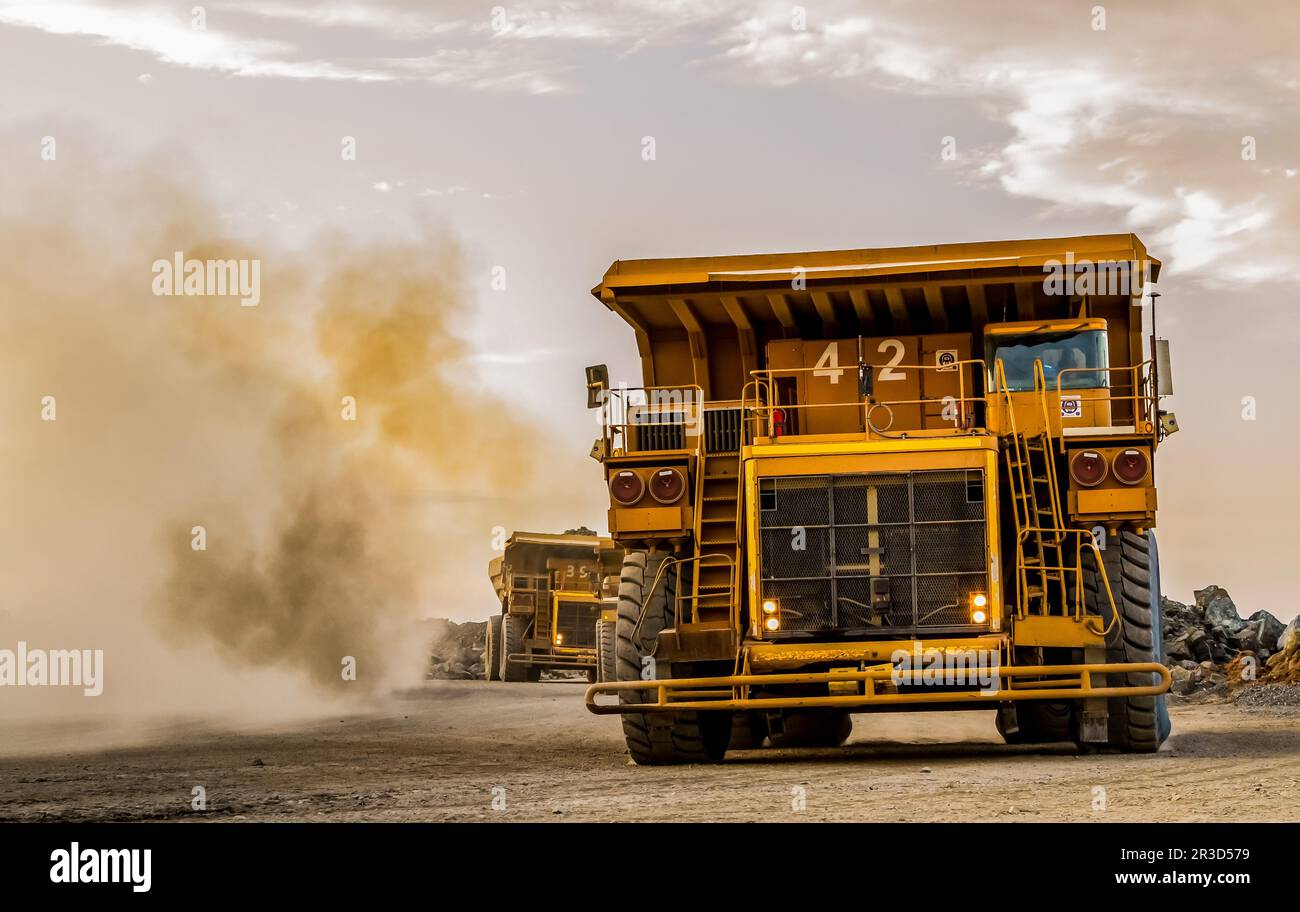 Mining dump trucks transporting Platinum ore for processing Stock Photo