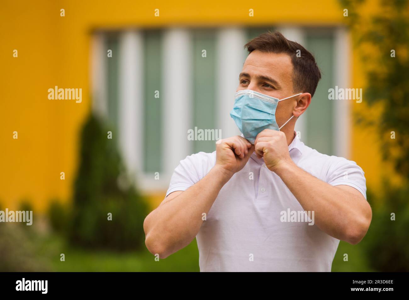 The man dresses up a face mask to protect from the coronavirus Stock Photo