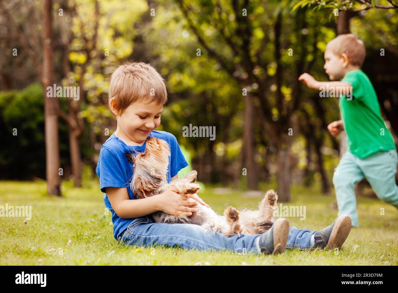 Harmonious children's life with a four-legged friend Stock Photo