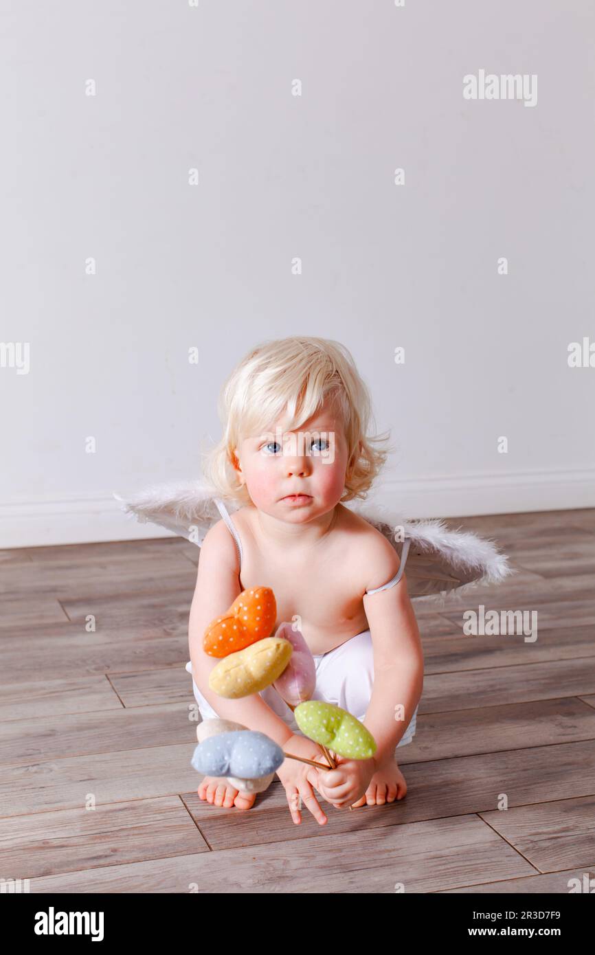 Infant baby with angel wings on neutral background Stock Photo