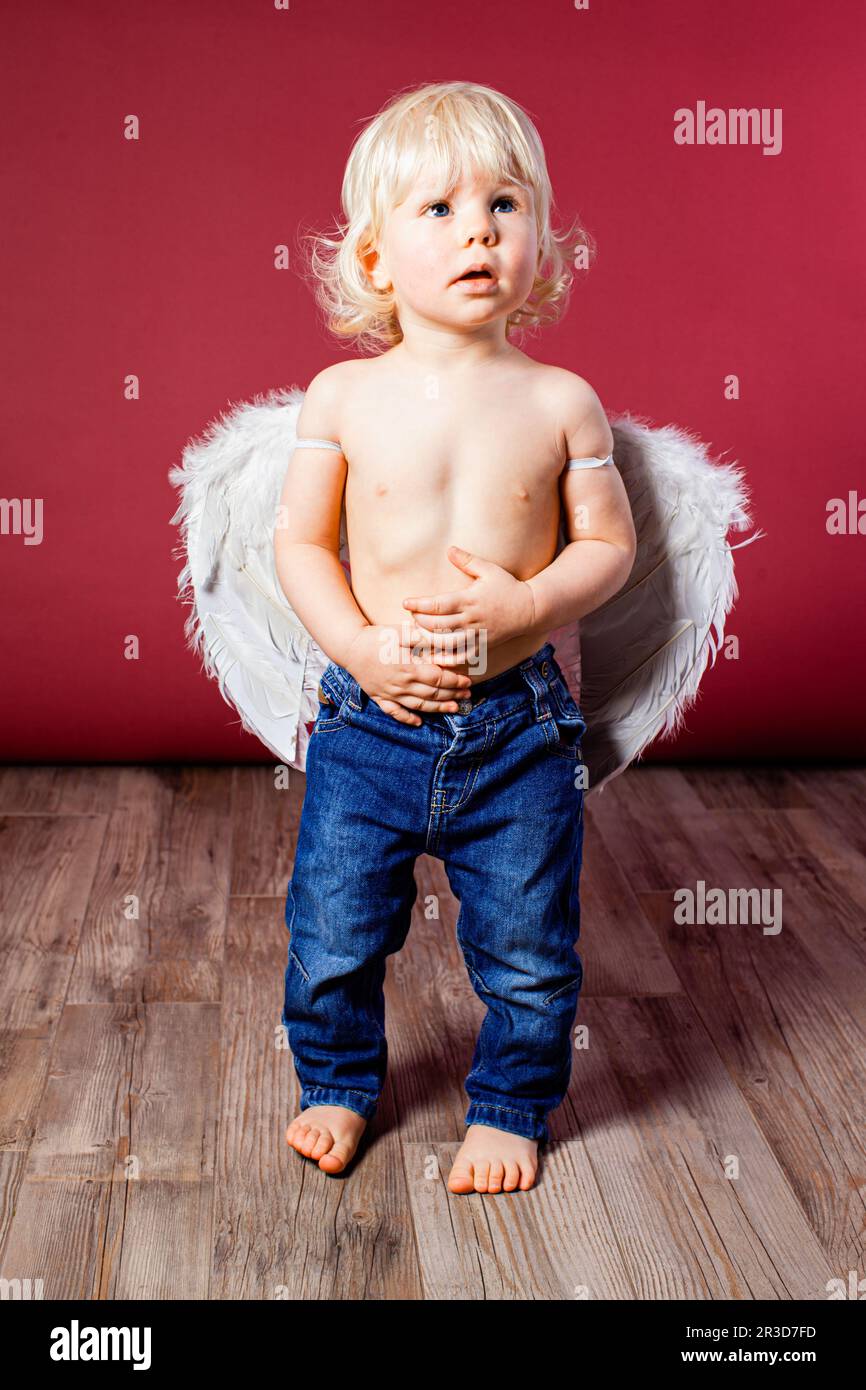 Infant baby with angel wings and jeans Stock Photo