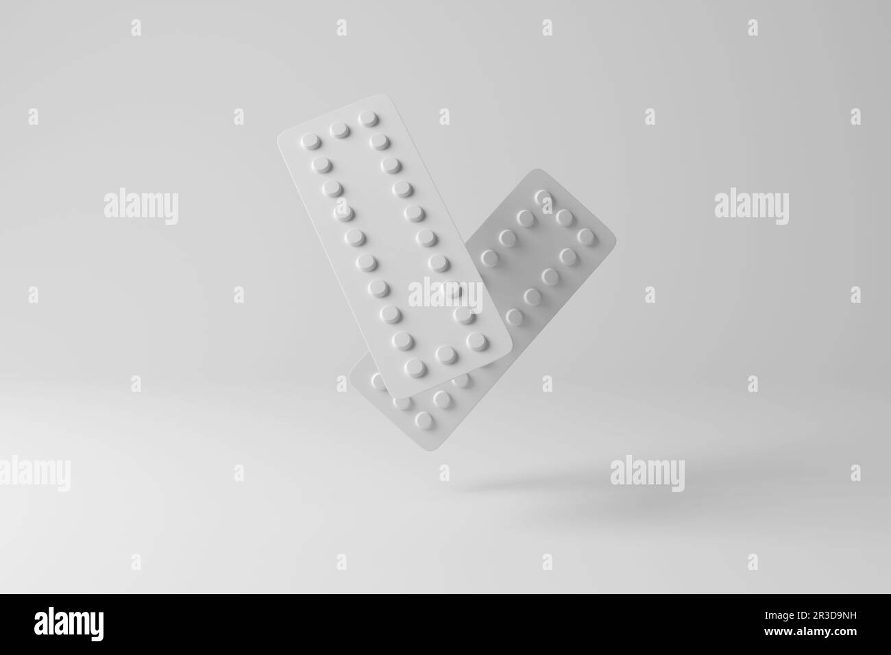 White blister packs of pills floating in mid air casting shadow on white background in greyscale monochrome. Over-the-counter medicine, prescriptions Stock Photo