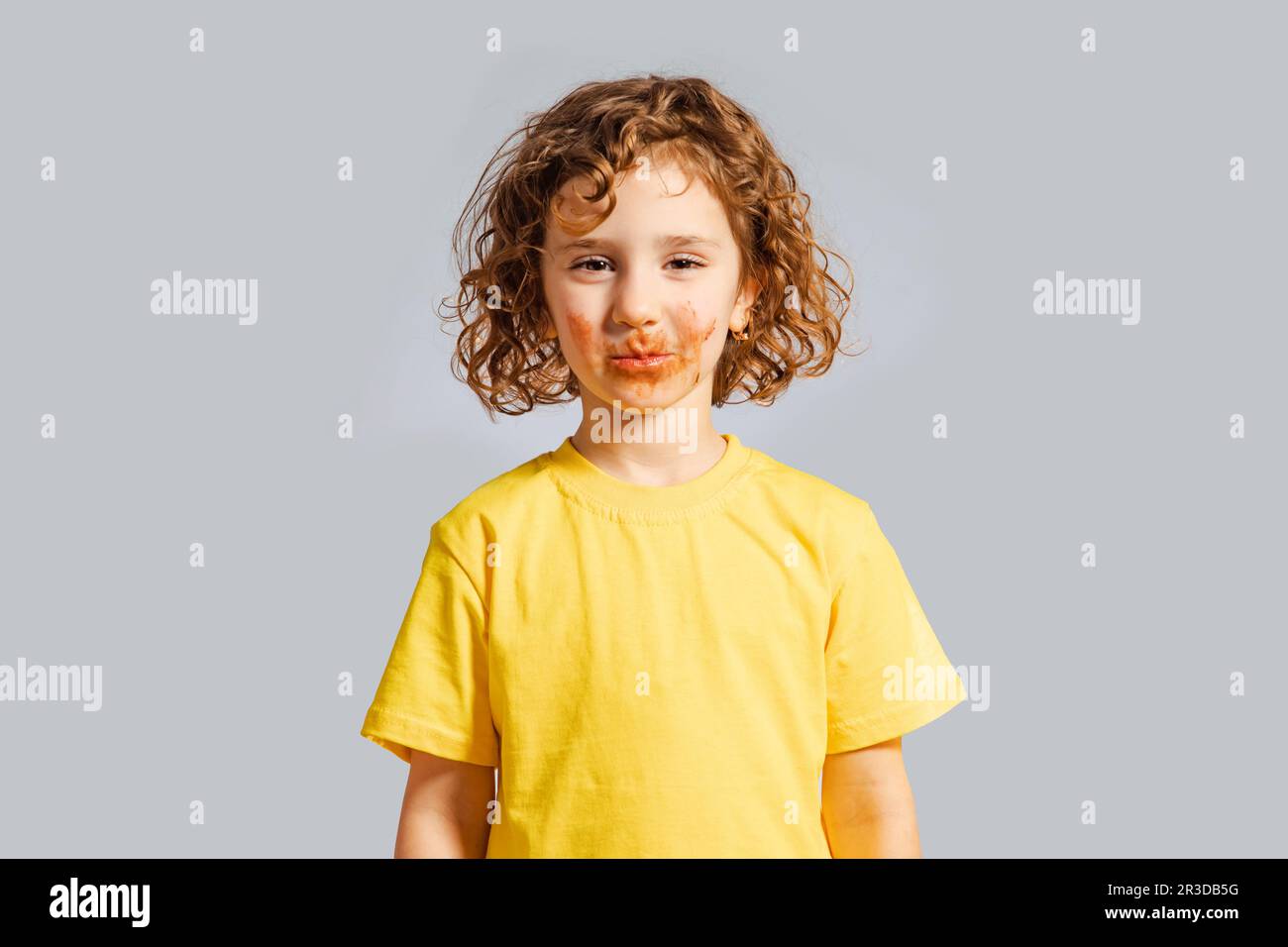The happy girl with a dirty mouth from chocolate Stock Photo