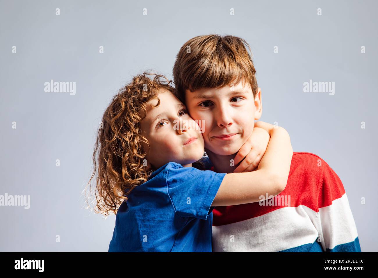 The cute little girl hugs her brother tightly Stock Photohttps. heart_plus....