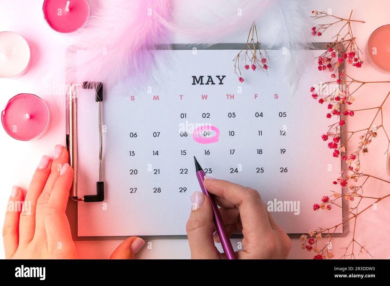 Calendar 9th of May date. Candles flowers feather. Happy Mothers day. Planning holiday. Flat lay. Top view. Stock Photo