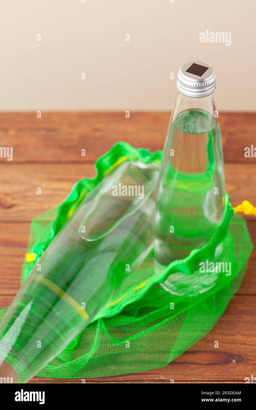 Mesh bags with reusable glass water bottle. Sustainable lifestyle. Zero  waste concept. No plastic Stock Photo - Alamy
