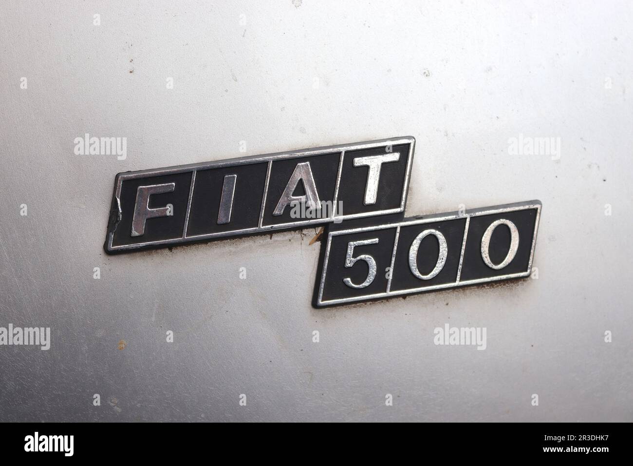 Fiat 500 badge fitted to the rear engine cover of a sliver example of one these cult cars. The Cinquecento is still seen in the streets of Rome today. Stock Photo