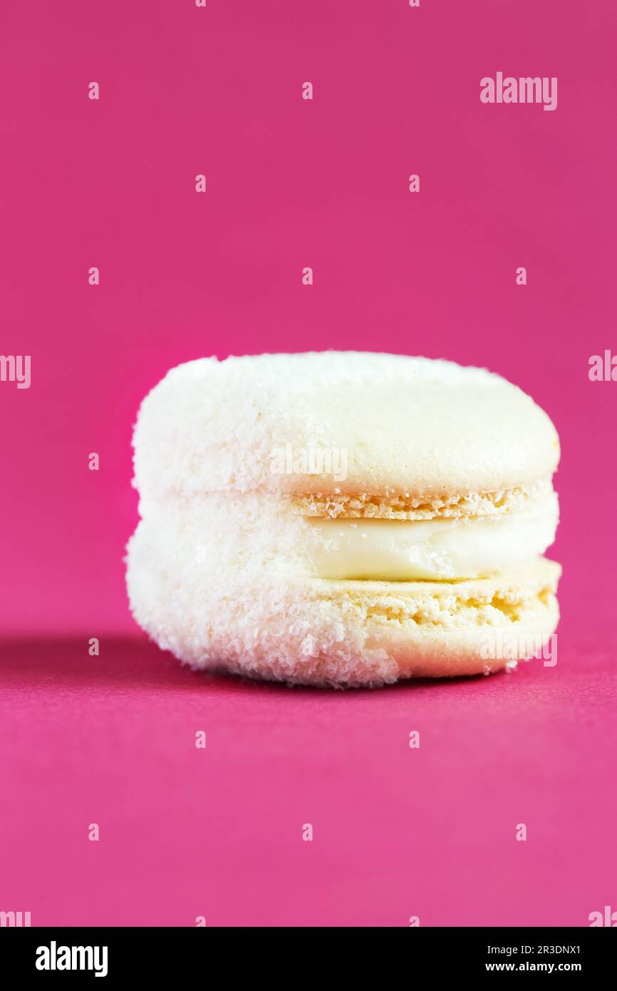 White Cake macaron or macaroon on pink background. Stock Photo