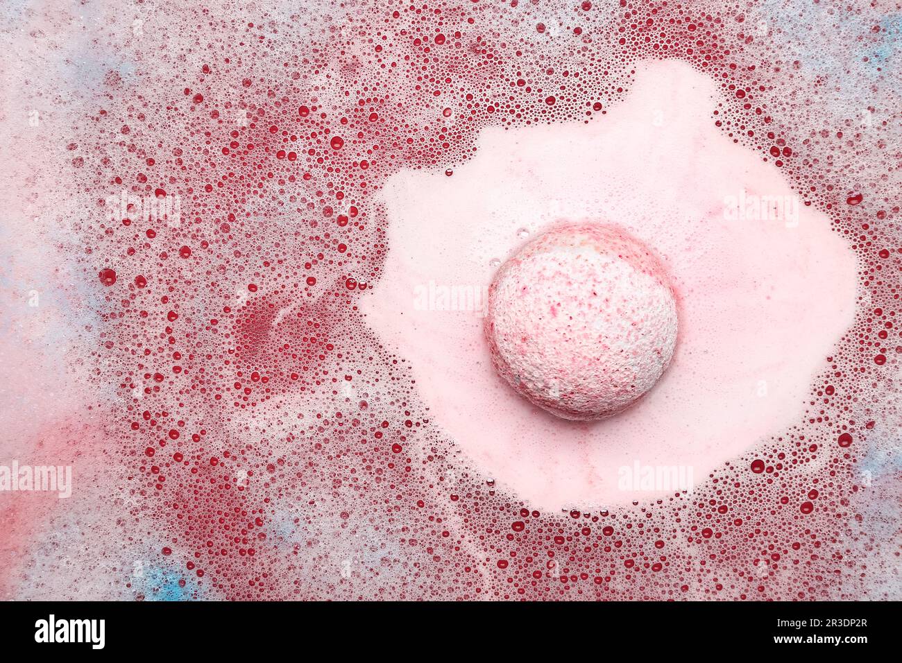 Pink bath bomb dissolving in water Stock Photo - Alamy