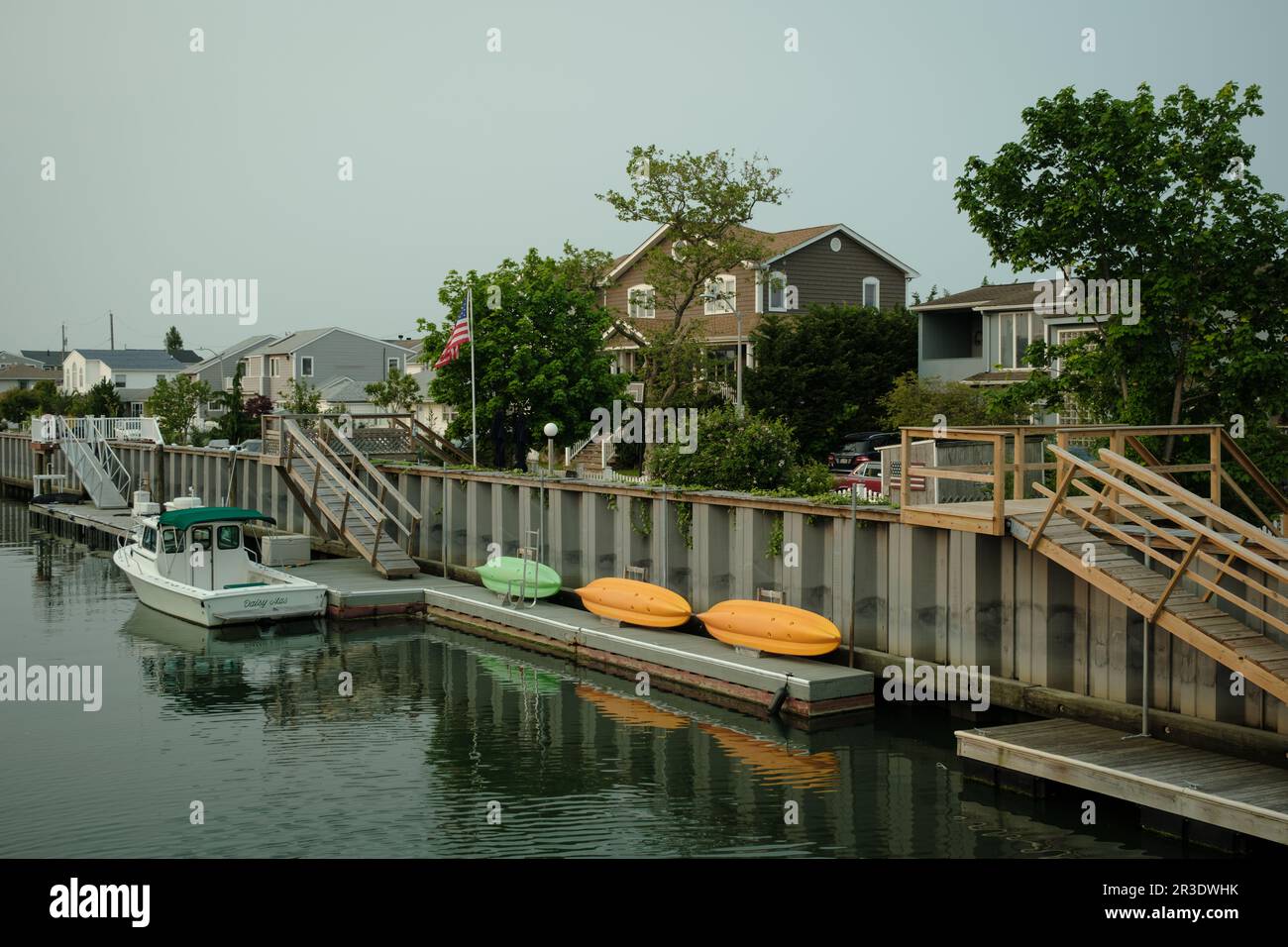 Canal with house and boats in Long Beach, New York Stock Photo