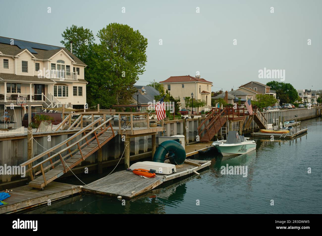 Canal with house and boats in Long Beach, New York Stock Photo
