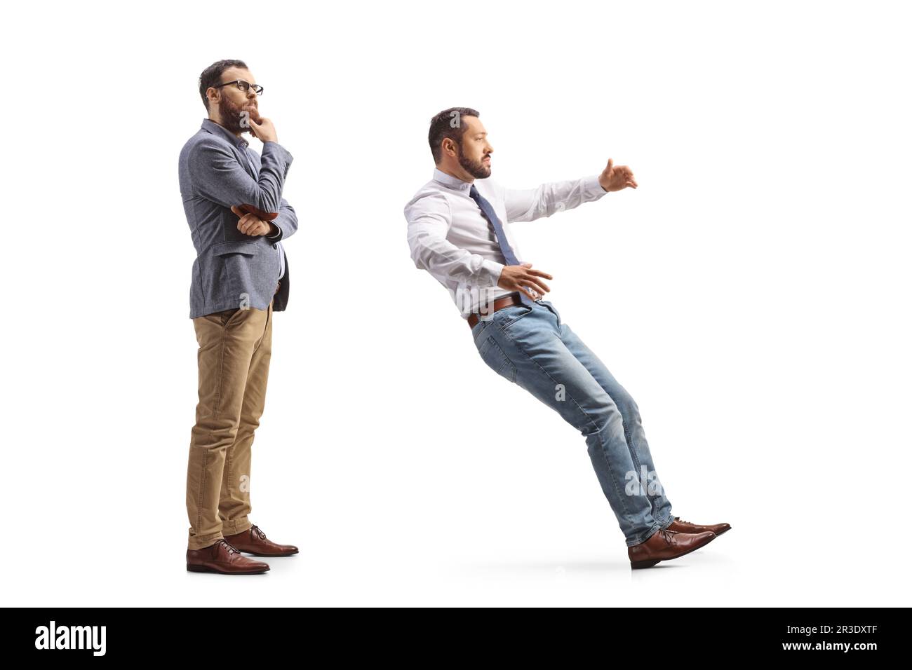 Full length profile shot of a pensive man standing behind a man falling