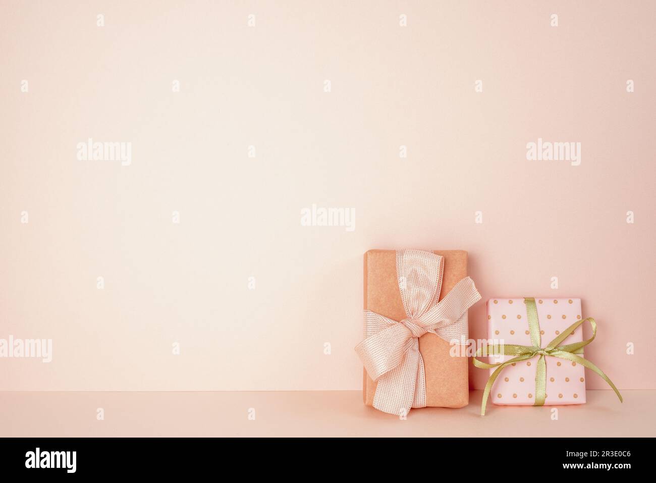 Pink gift boxes on pink table. pink wall background. copy space Stock Photo