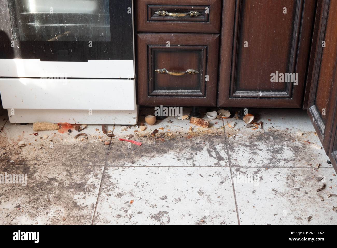 Dirty kitchen floor. Very dirty light tile floor in the kitchen