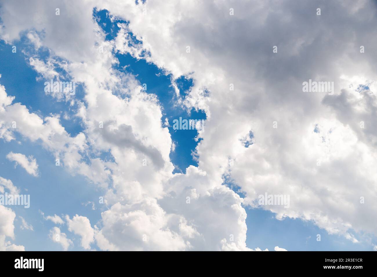 Blue sky and white fluffy clouds background Stock Photo - Alamy