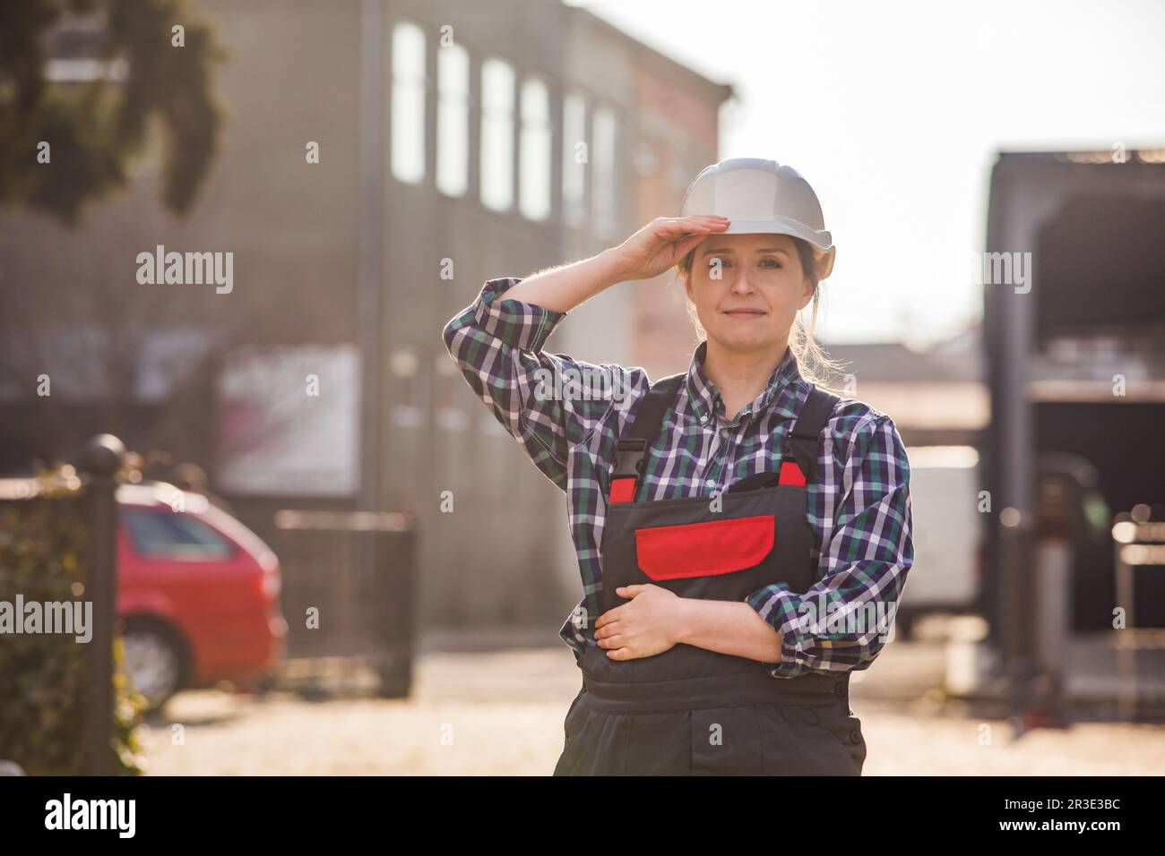 Young girl, manual worker posing outdoors with hands folded on chest Stock Photo