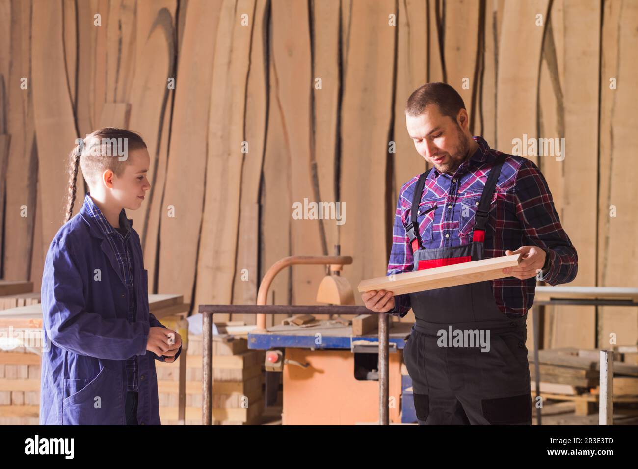 Young apprentice learning to work at carpentry shop Stock Photo - Alamy