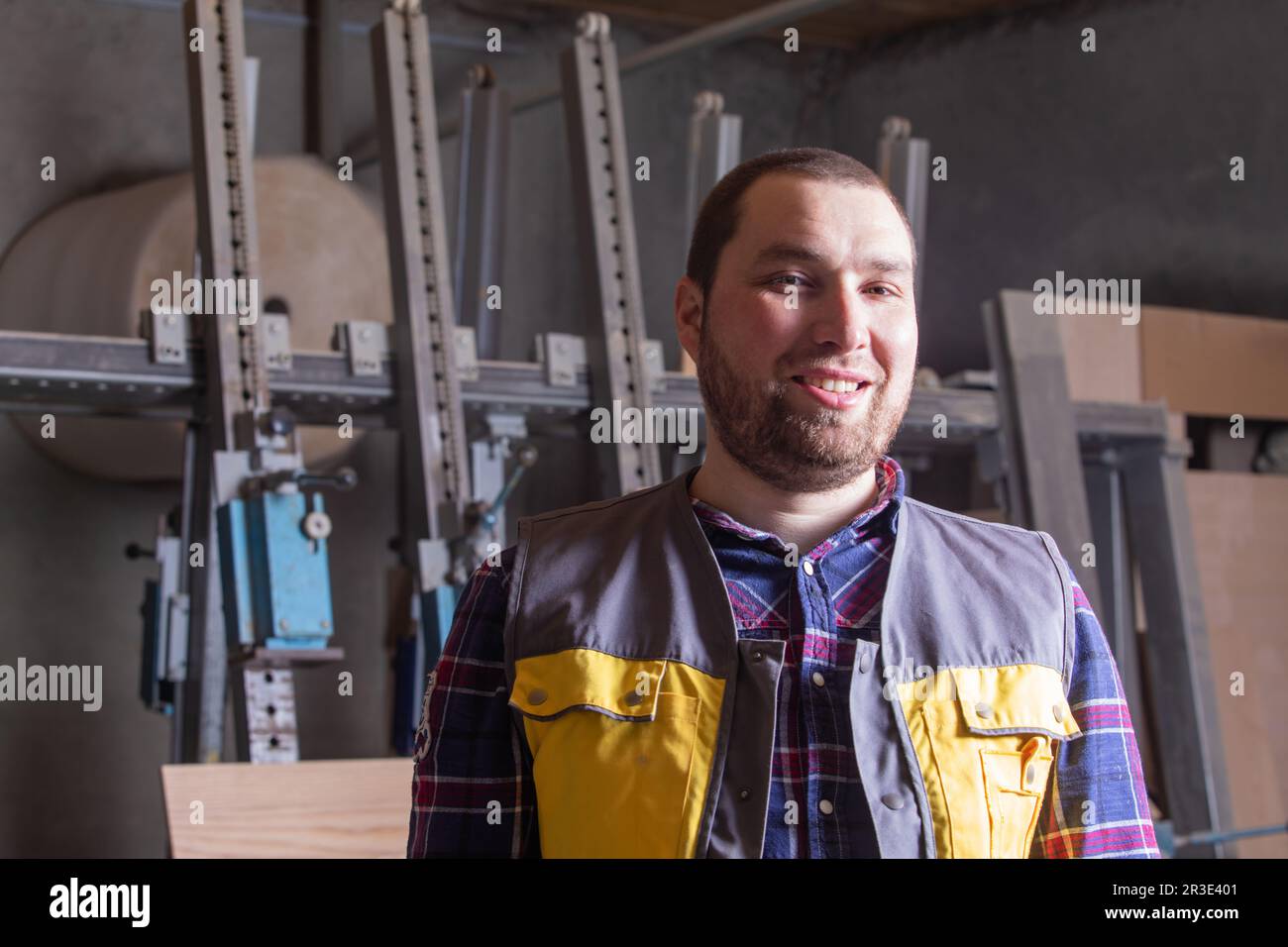 Proud carpenter at woodworking factory working place Stock Photo