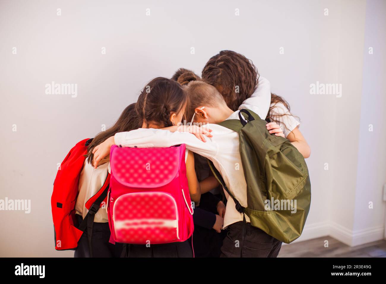 Happy school kids are ready for education. School children in uniform with backpacks going to class Stock Photo