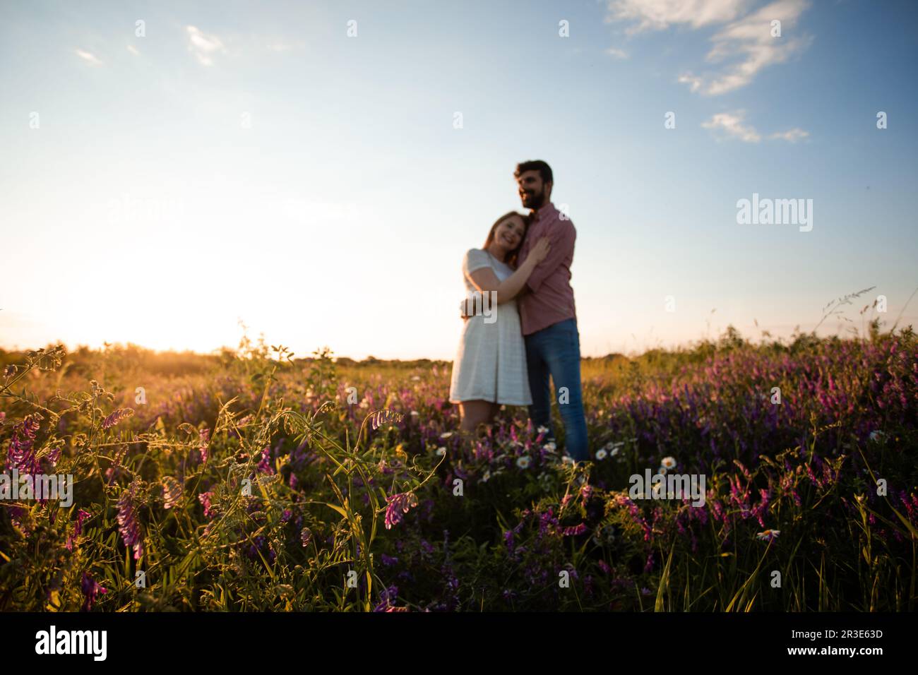 Happy couple embracing outdoors in the meadow Stock Photo - Alamy