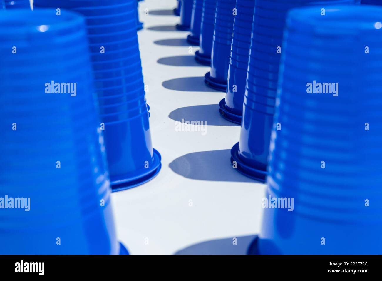 Blue Plastic Drinking Cups in rows background Stock Photo
