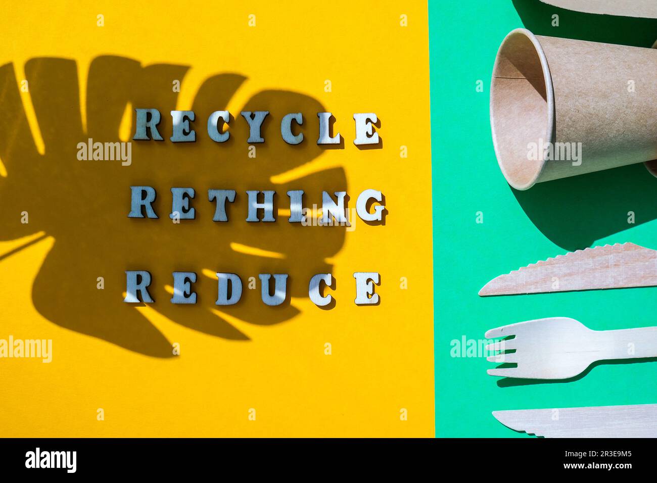 RECYCLE RETHING REDUCE text Wooden forks and paper cups with plates on