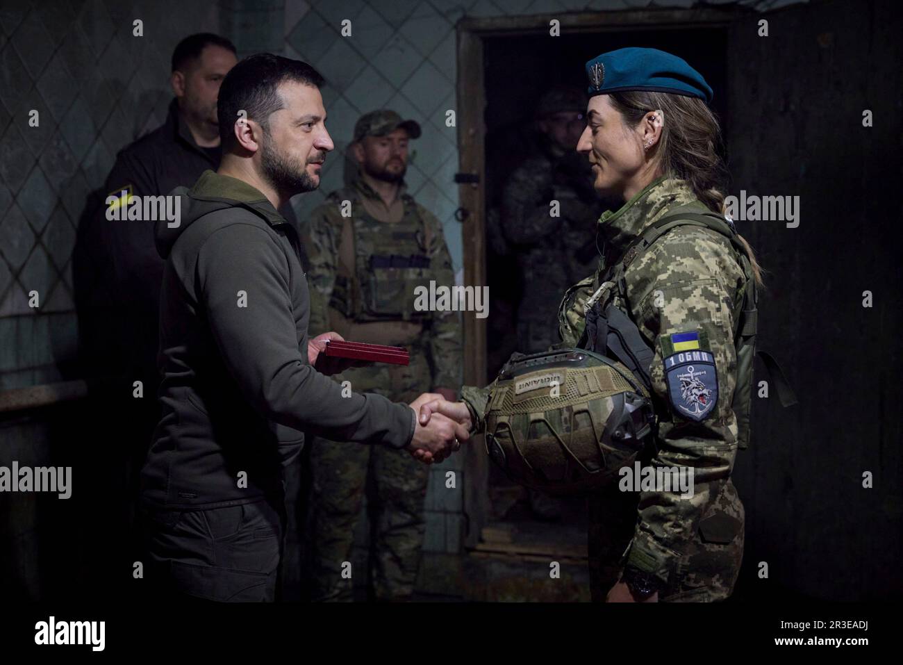 Vuhledar, Ukraine. 23rd May, 2023. Ukrainian President Volodymyr Zelenskyy, left, awards state medals to a female Ukraine Marine during a visit to frontline positions in the Donetsk region, May 23, 2023 in Vuhledar, Donetsk Oblast, Ukraine. Zelenskyy visited the troops to celebrate the Day of the Marines. Credit: Pool Photo/Ukrainian Presidential Press Office/Alamy Live News Stock Photo