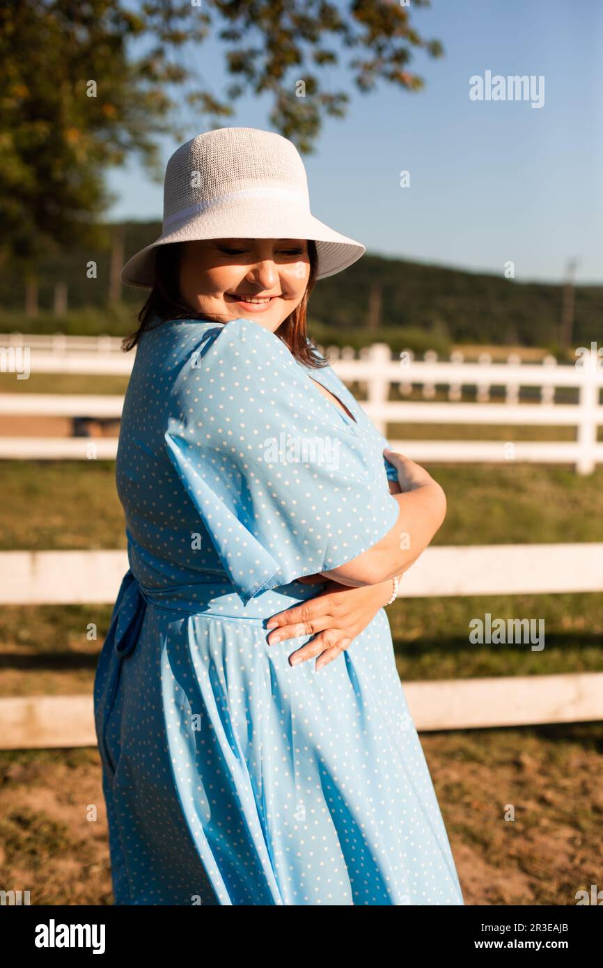 Candid woman in hat at farmland enjoy the summer Stock Photo