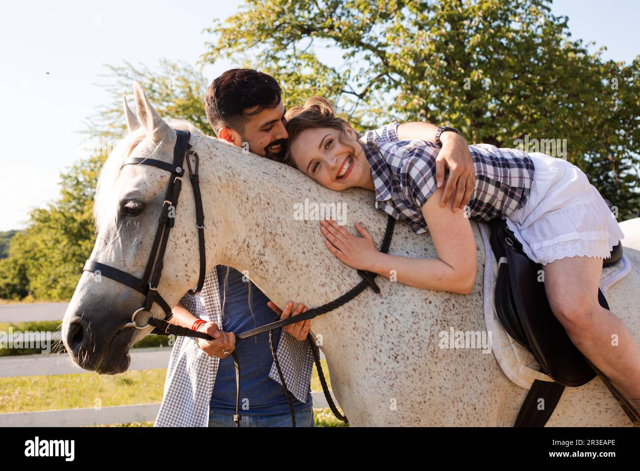 The young couple are having fun time with horse Stock Photo