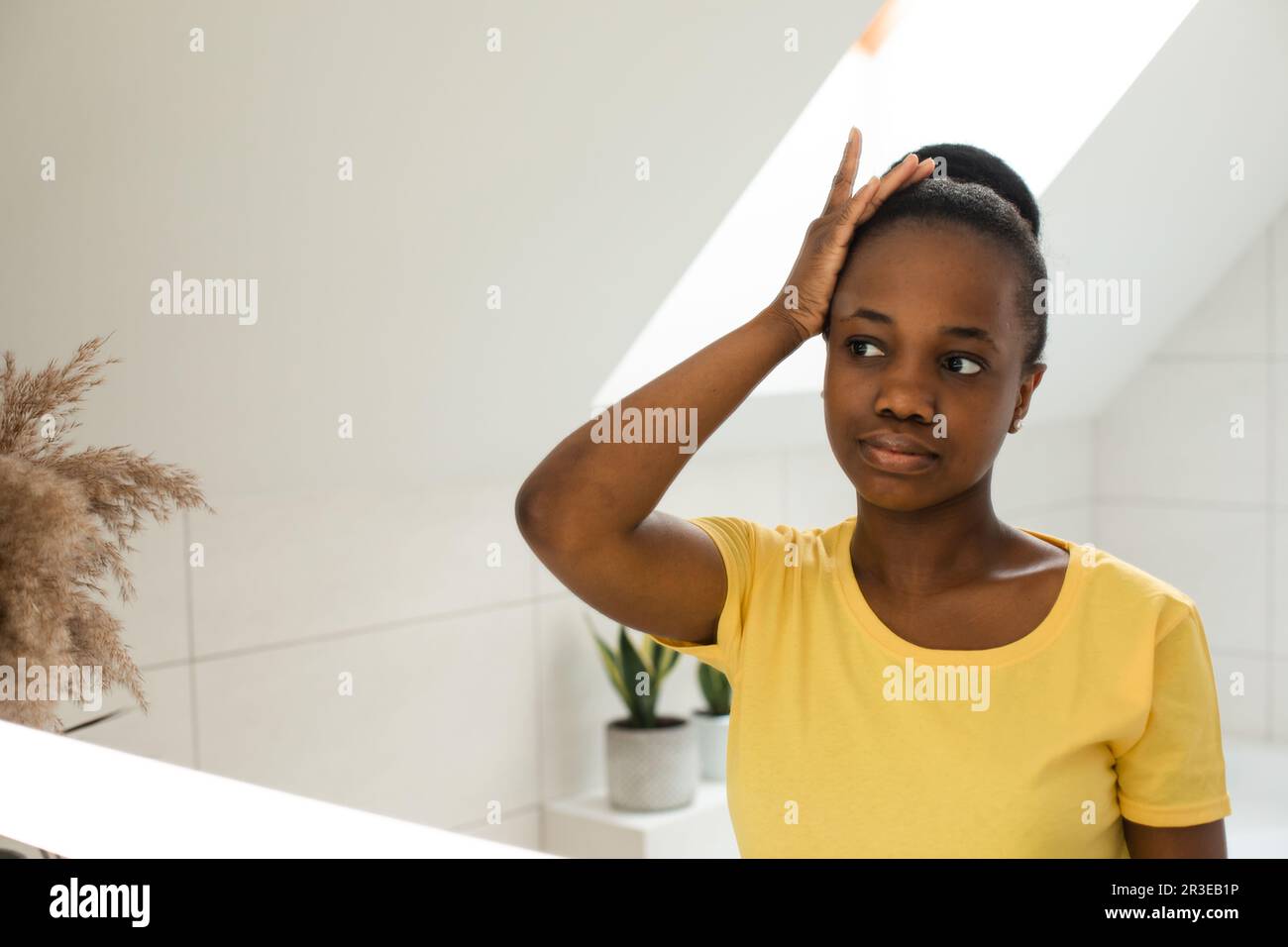Everyday hair care routines for african girl Stock Photo