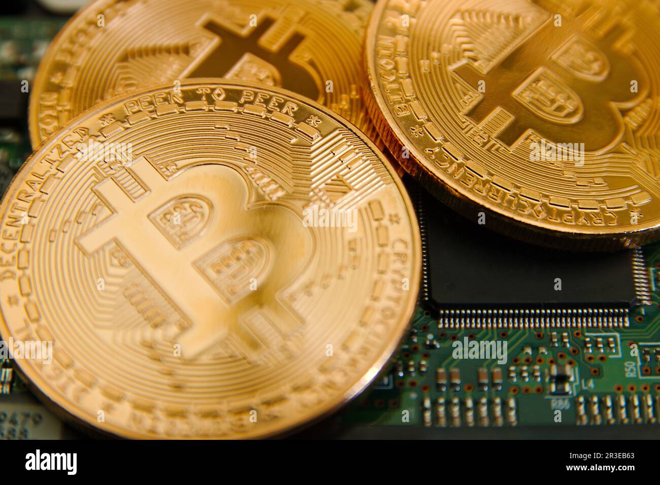 Conceptual cryptocurrency bitcoins on a computer motherboard Stock Photo