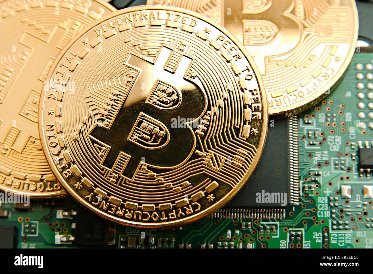Conceptual cryptocurrency bitcoins on a computer motherboard Stock Photo