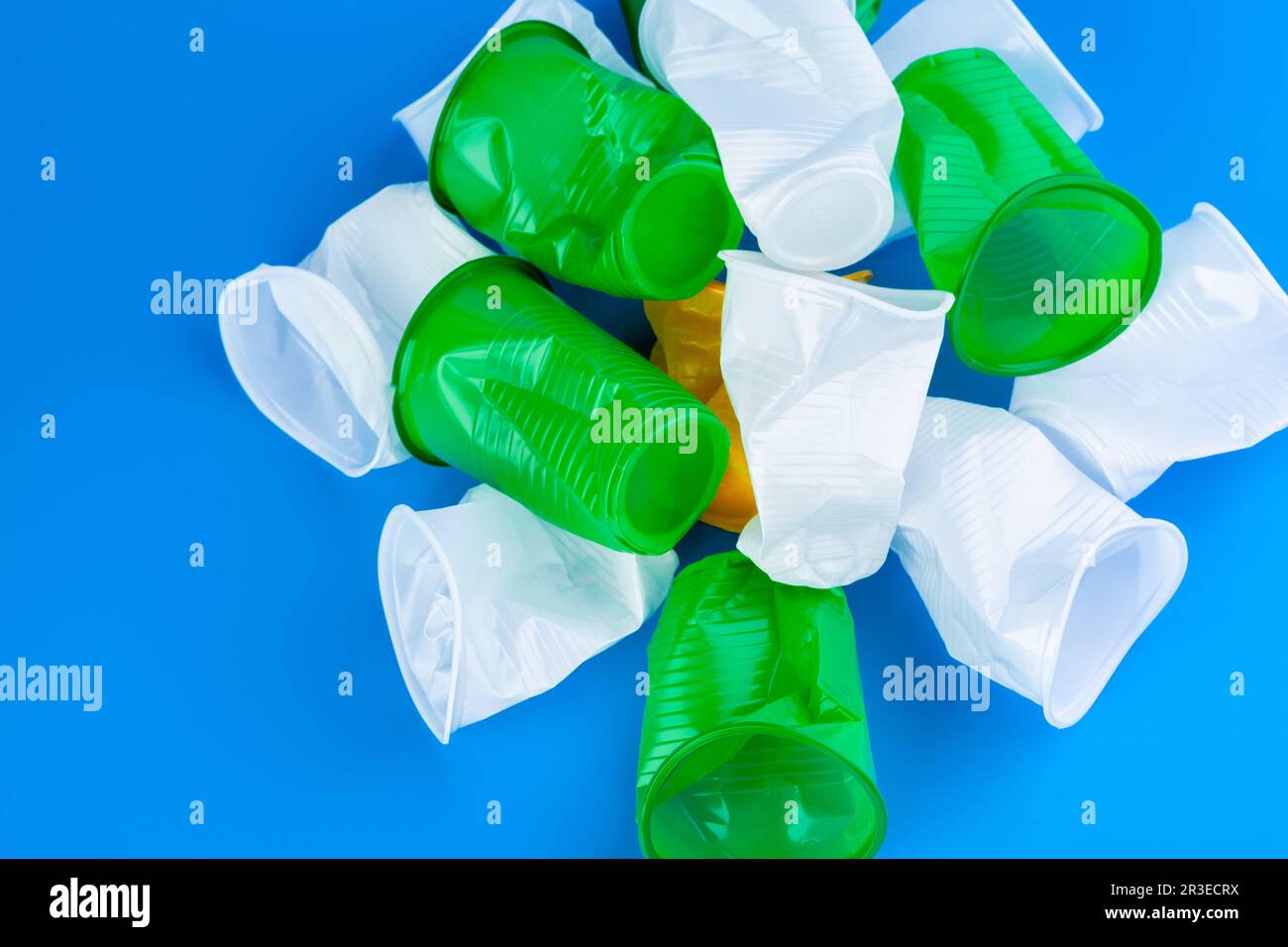 Crumpled empty singleuse plastic cups, studio shot. Plastic pollution