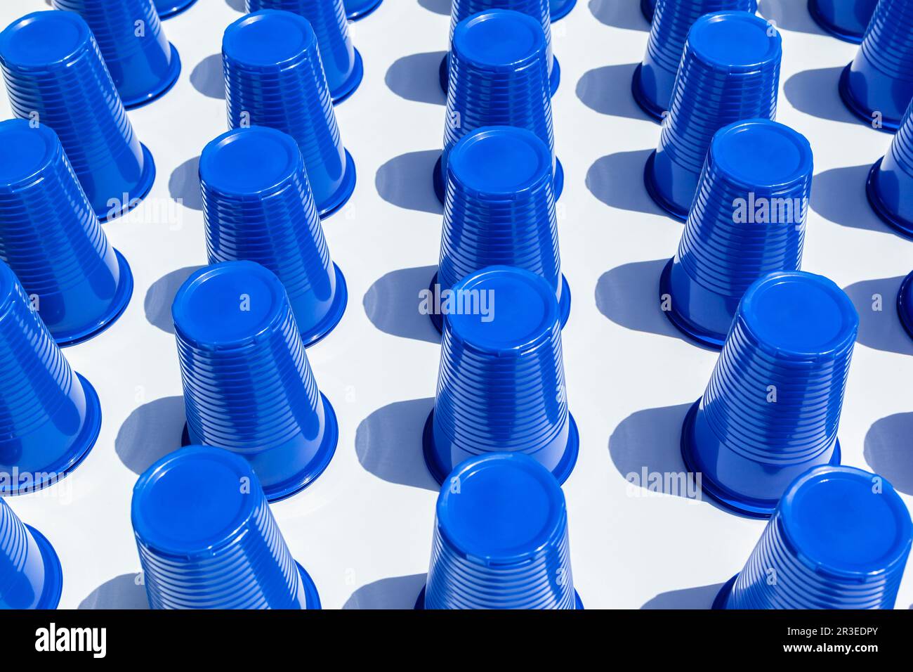 Blue Plastic Drinking Cups in rows background Stock Photo