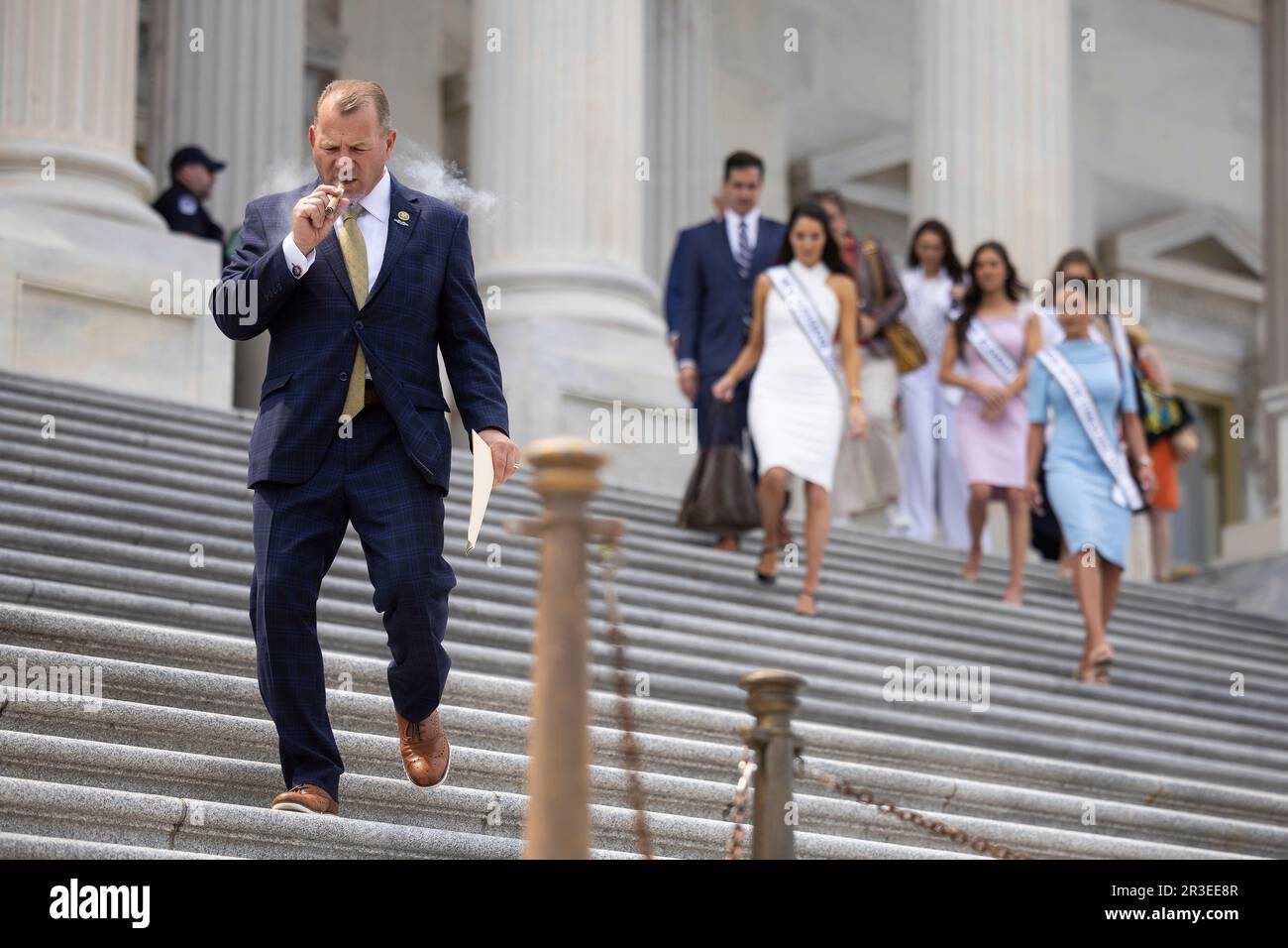 Rep. Troy Nehls (RTexas) smokes a cigar as he departs a vote at the U