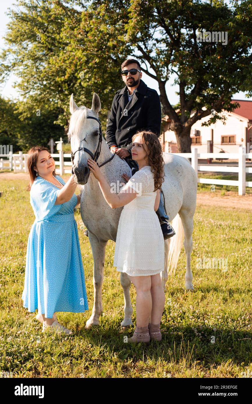 The young man is riding a horse on a farm Stock Photo - Alamy