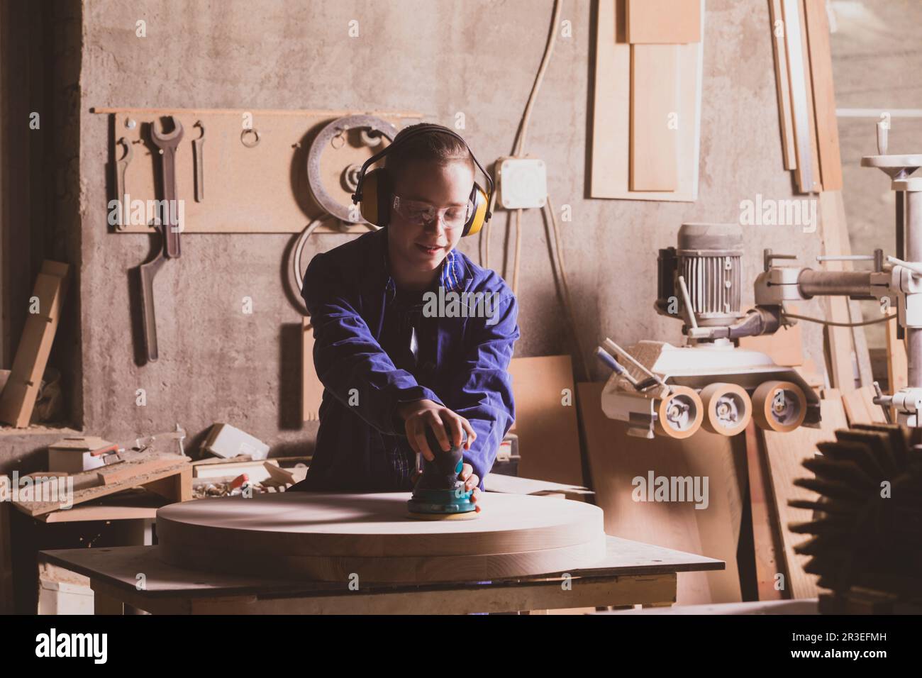Safety in woodworking. Female carpenter in googles and dust mask Stock Photo