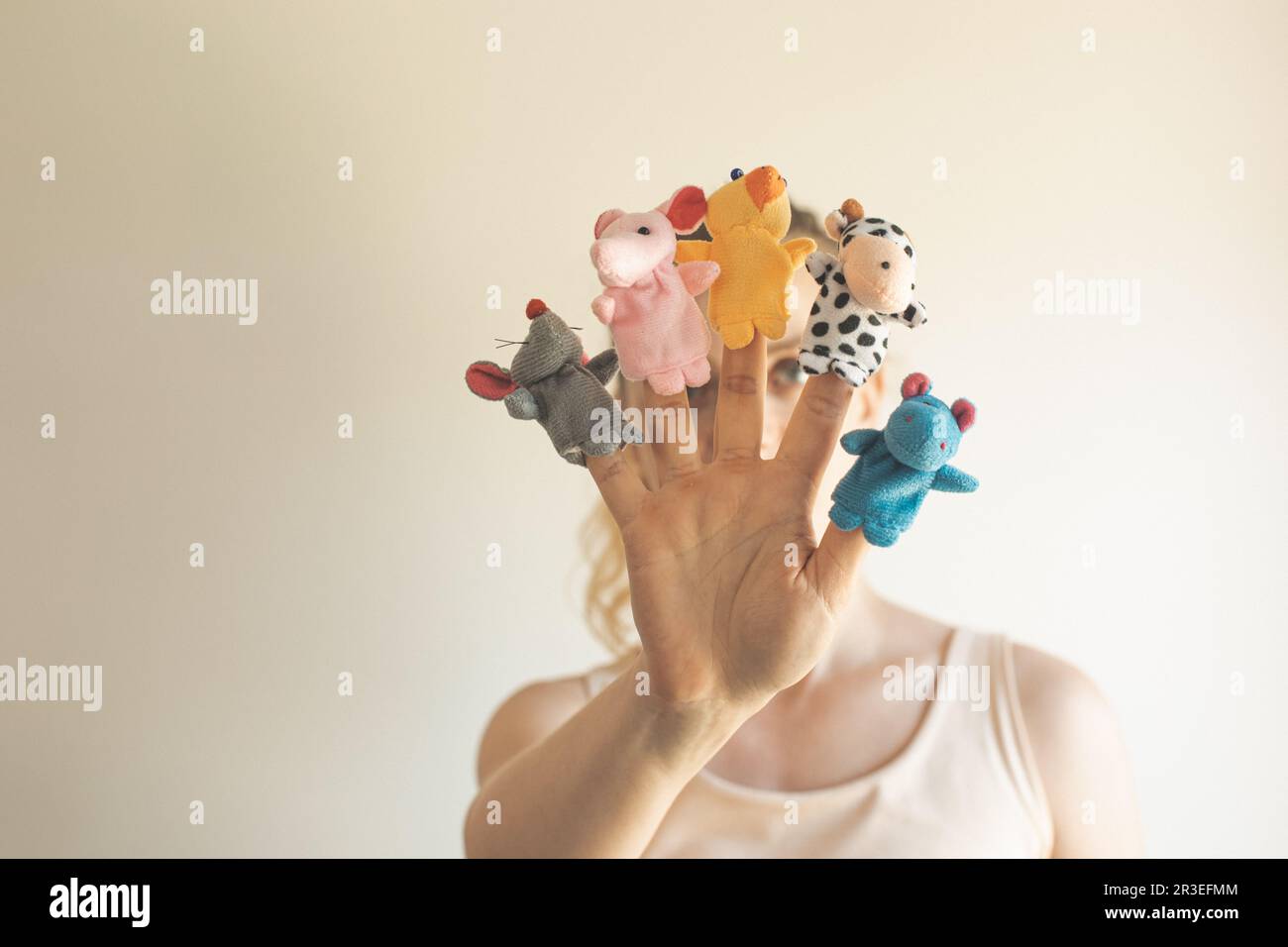 Woman hand wearing five finger puppets close up Stock Photo