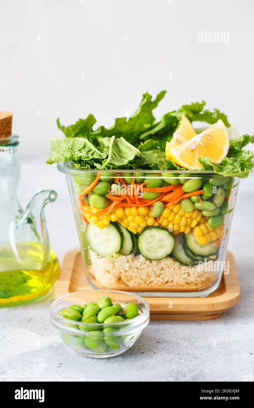 Glass box with fresh raw vegetable salad. Healthy Meal recipe preparation. Healthy vegan dishes in glass container. Vegetarian c Stock Photo