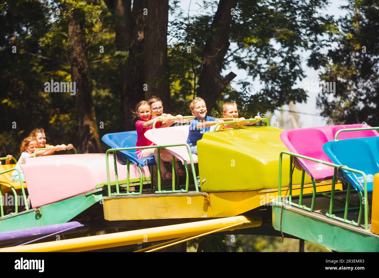 The children experience great emotions of roller coaster riding Stock Photo