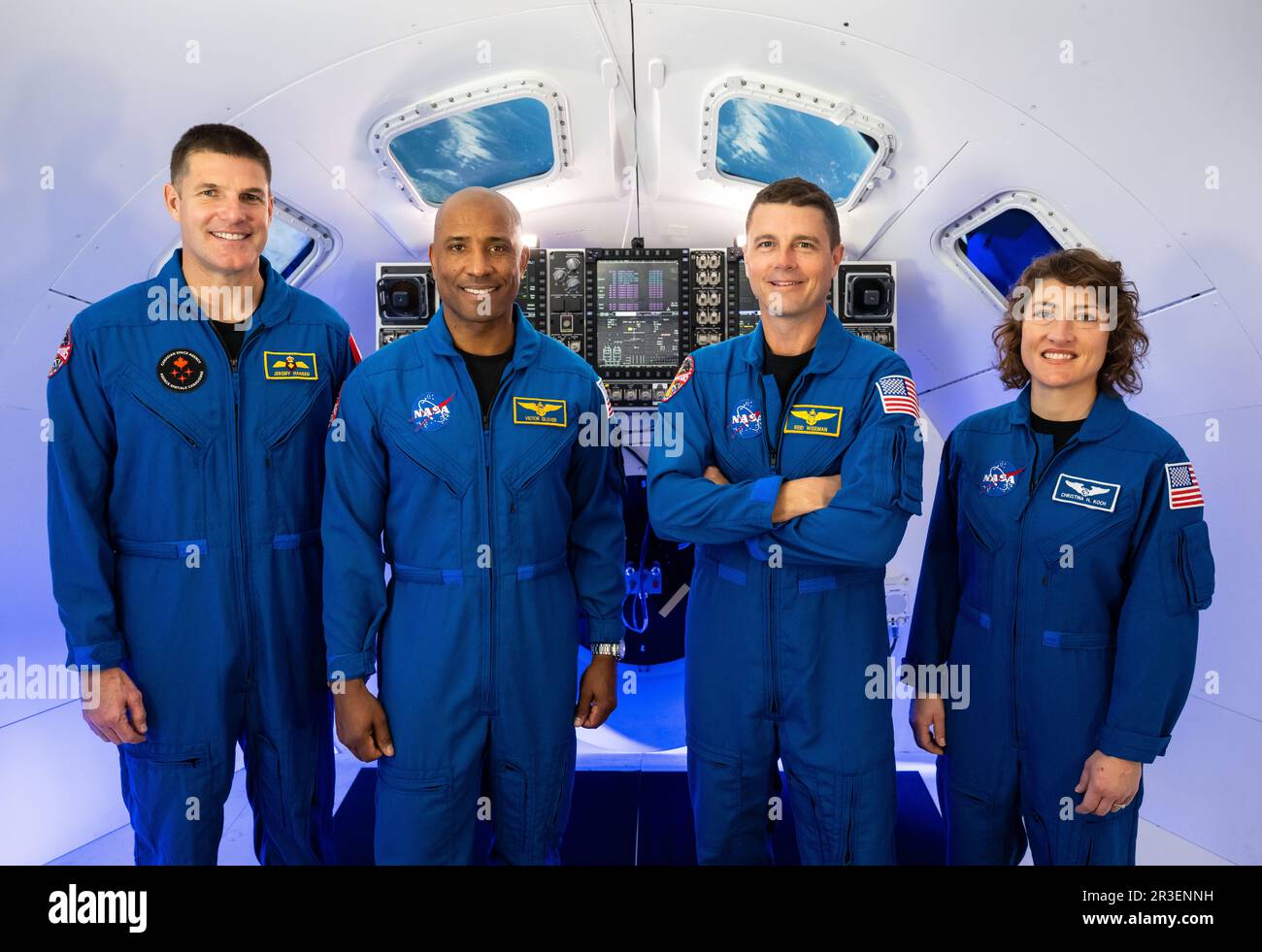 Houston, United States. 29 March, 2023. Artemis II astronauts poses in blue flight suits inside the Orion Simulator at the Johnson Space Center, March 29, 2023 in Houston, Texas. Standing from left: CSA astronaut Jeremy Hansen, NASA astronauts Victor Glover, Reid Wiseman, and Christina Hammock Koch. Credit: James Blair/NASA/Alamy Live News Stock Photo