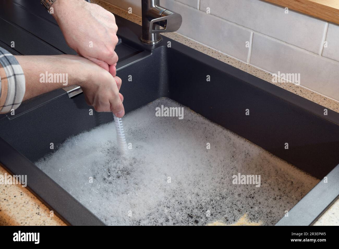 Overflowing kitchen sink, clogged drain, plumbing problems, trying to